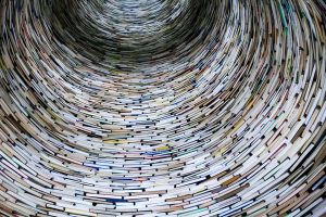 a large stack of books spiralling upawards for the english tuition page on the highland tutor website